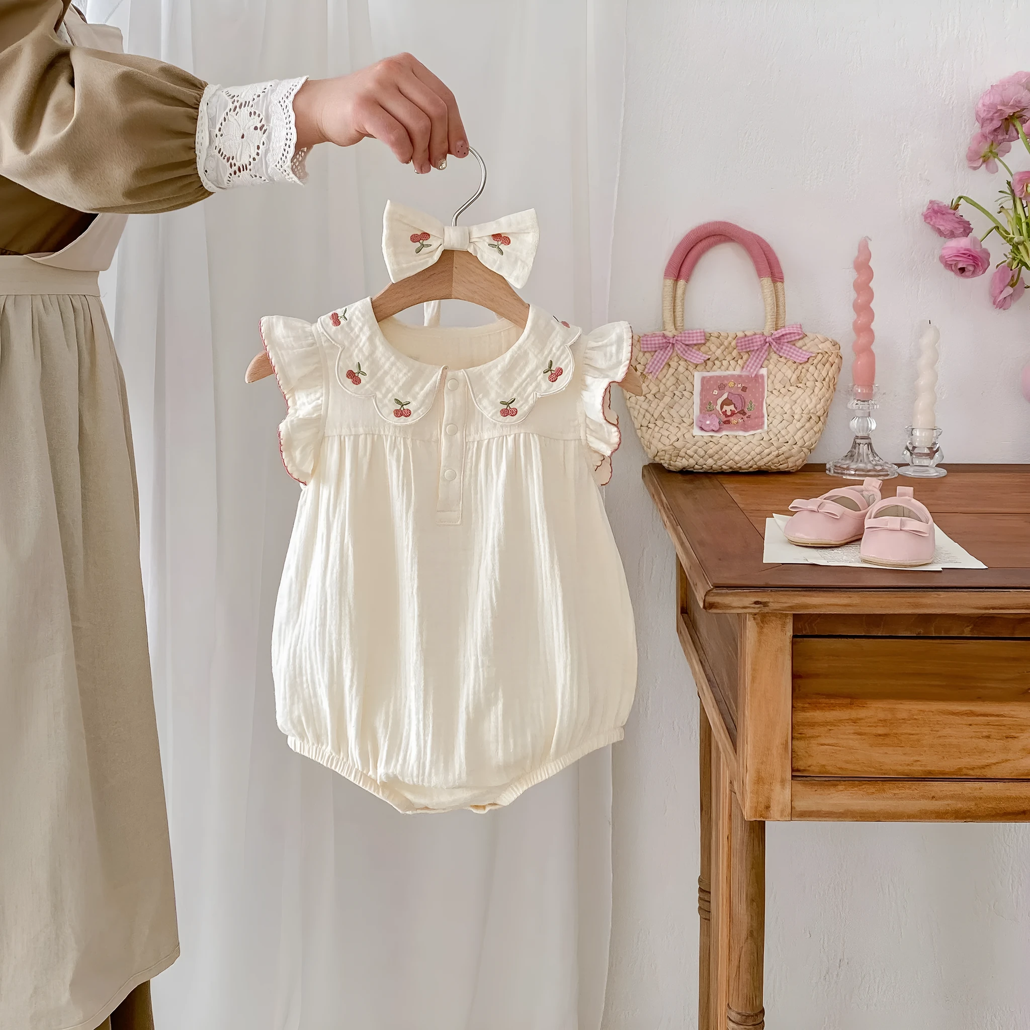 Summer cotton baby jumpsuit in apricot with double-breasted closure and matching hair band