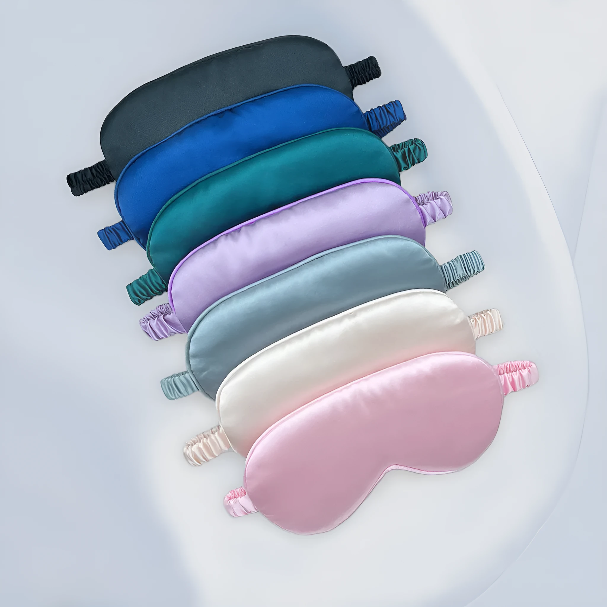 Rayon satin sleep mask in various colours showing double-sided silk-like fabric and elastic strap.