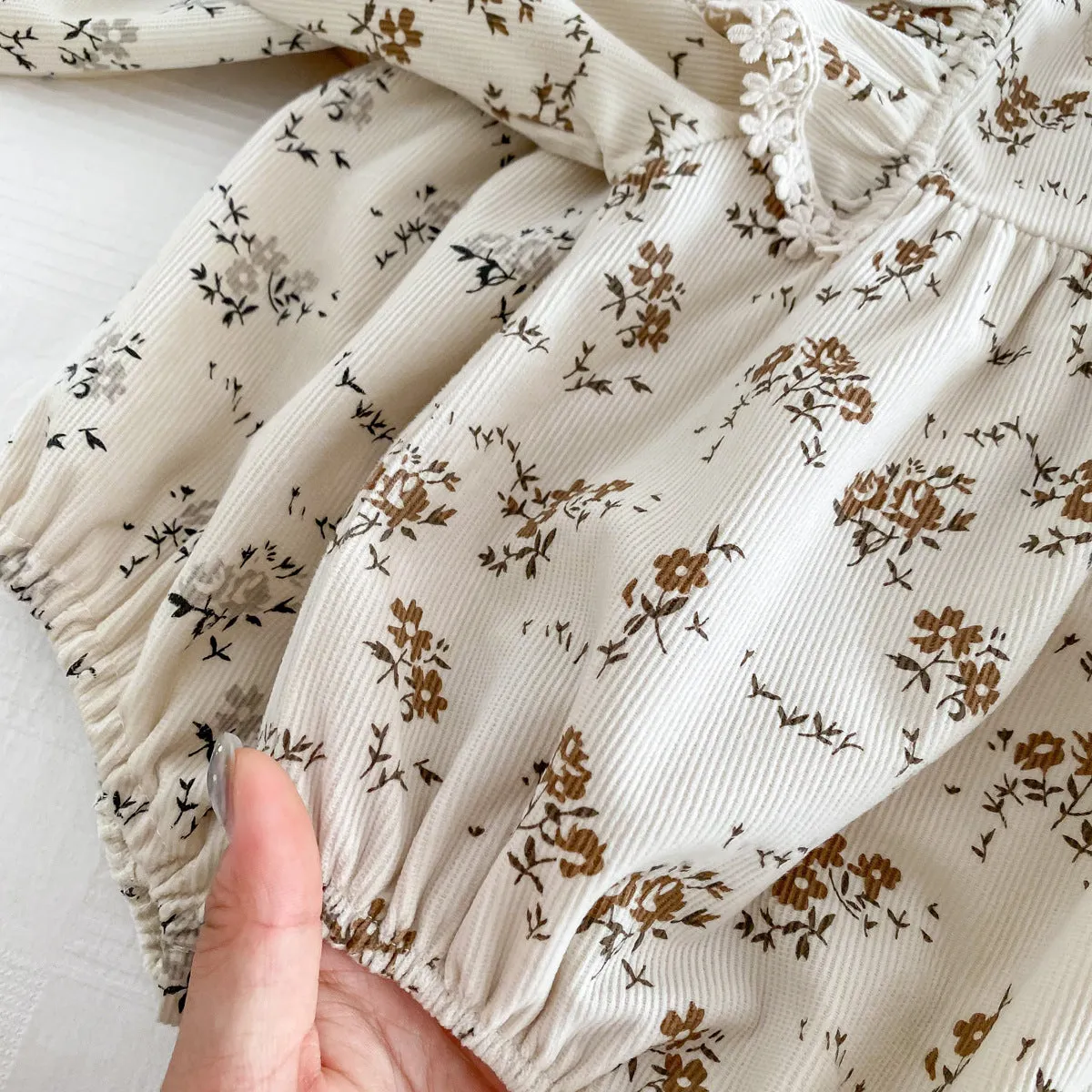 Baby girl corduroy floral jumpsuit in triangle style with long sleeves, round neck, available in black shivering colour