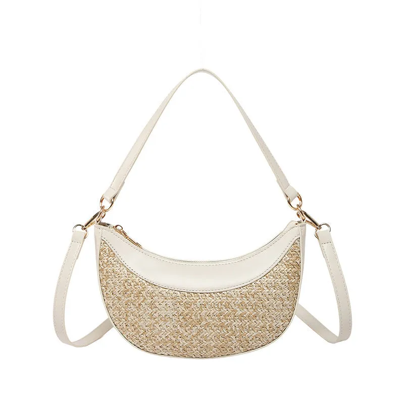 Hard straw women's crossbody dumpling bag in black with contrast stitching and internal organisation pockets.