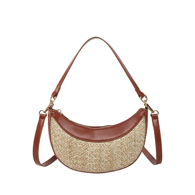 Hard straw women's crossbody dumpling bag in black with contrast stitching and internal organisation pockets.