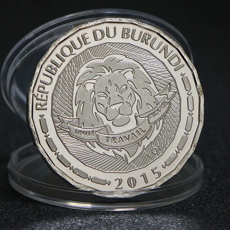 Set of eight silver plated commemorative coins with tropical fish and marine animal designs, 40mm diameter, in acrylic box