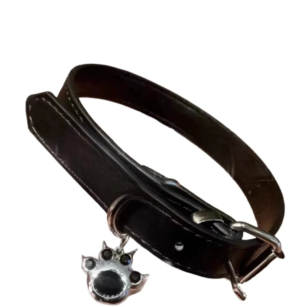 Black adjustable leather dog collar with decorative bone charm on a regular chain