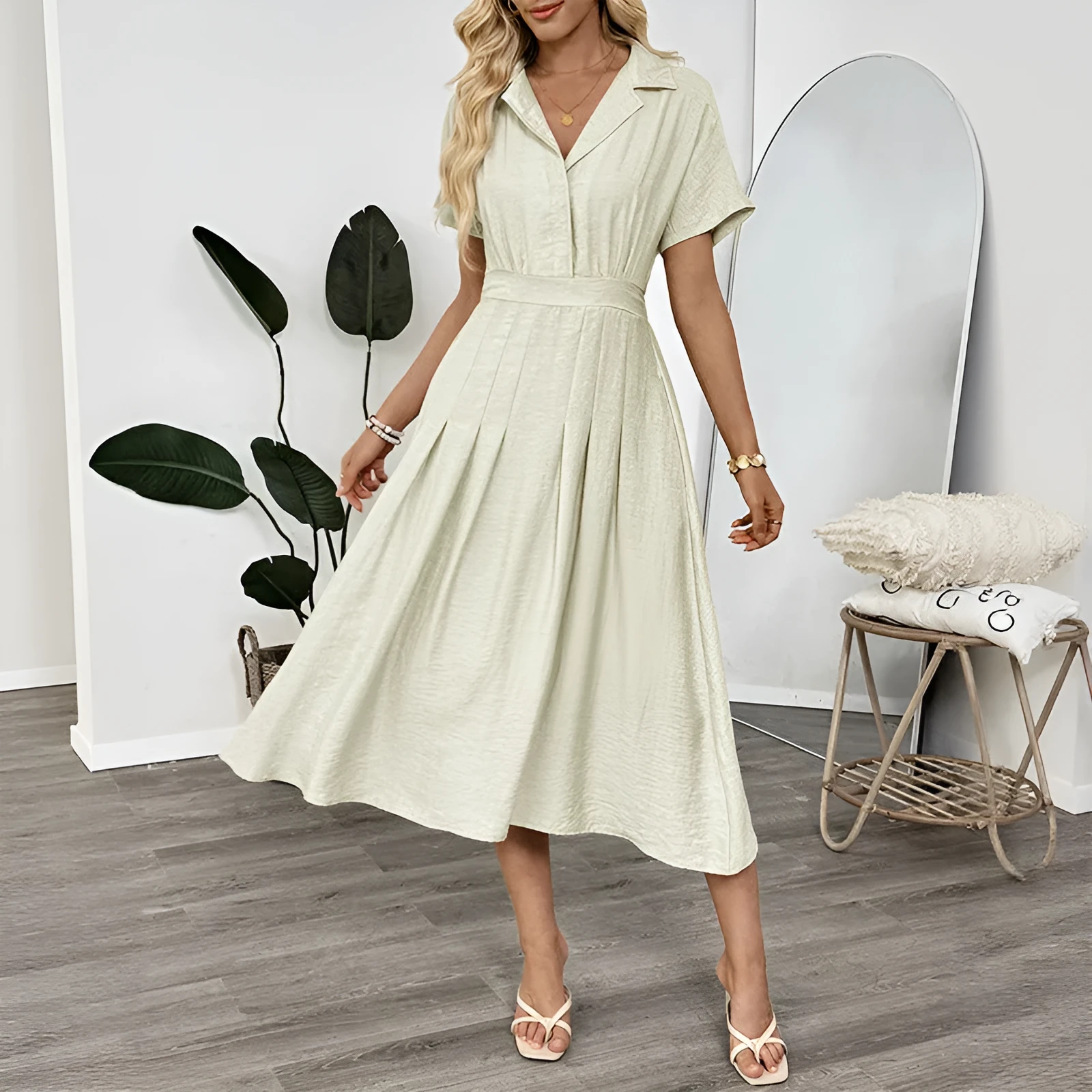 Light green commuter shirt dress with lapel collar, waist tie, and side pockets on a hanger.