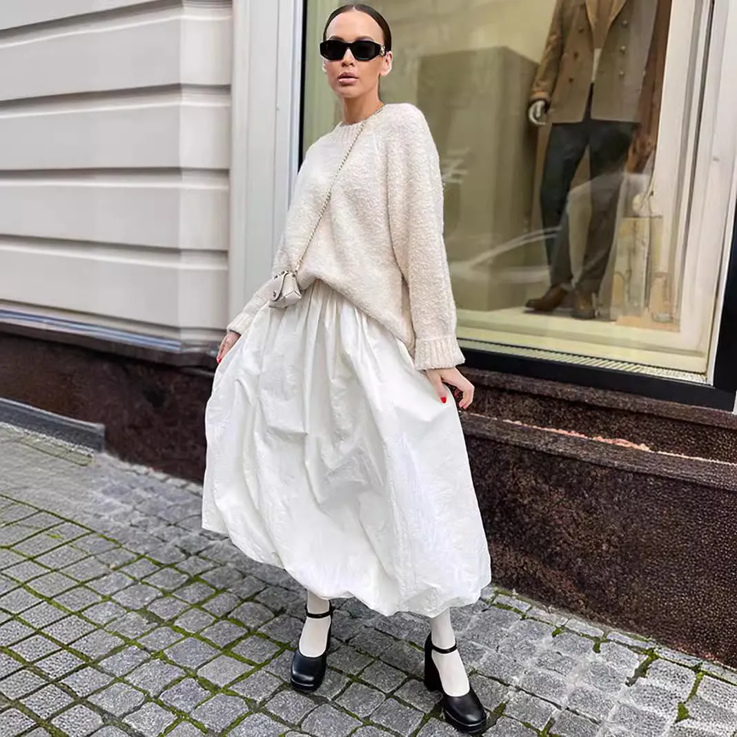 Women's solid colour cotton long skirt with elastic waistband in black or white.