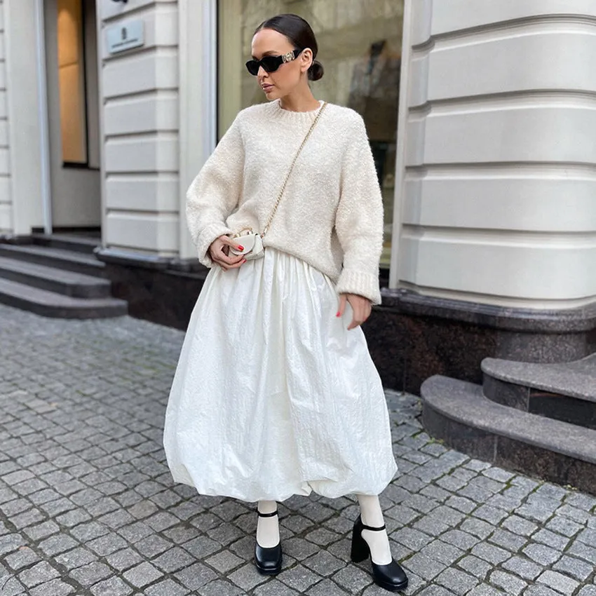 Women's solid colour cotton long skirt with elastic waistband in black or white.