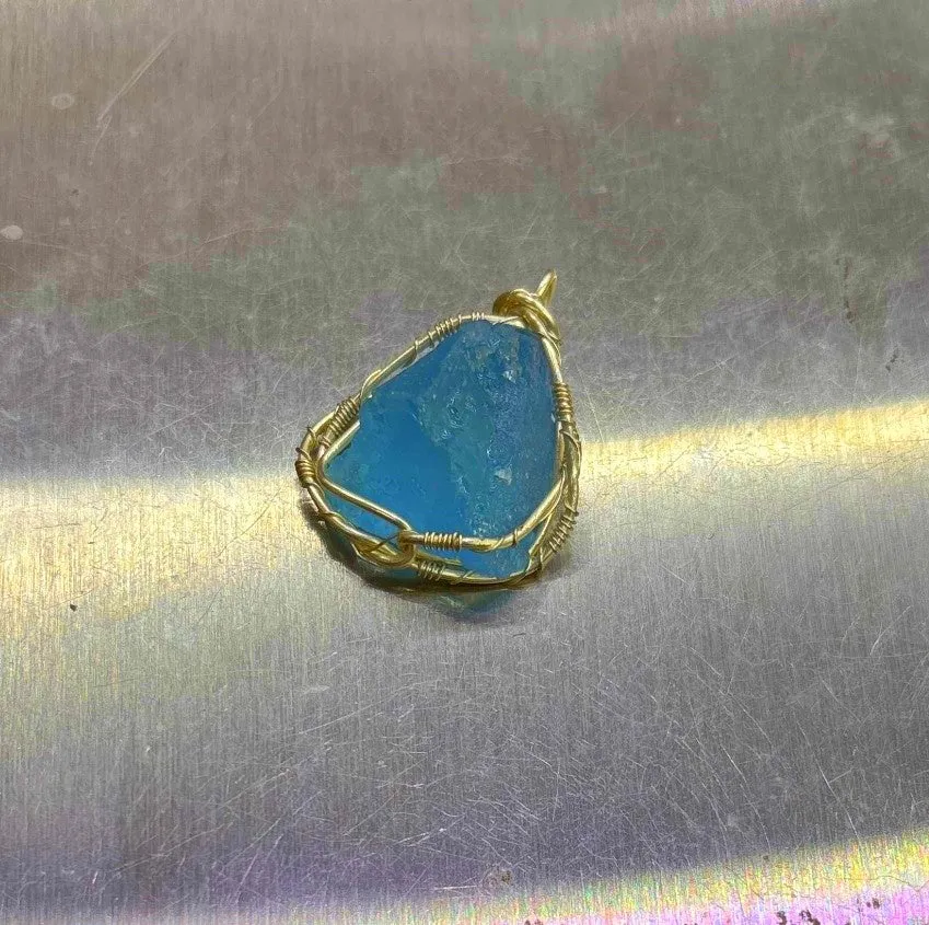 Natural raw aquamarine stone pendant hand-wrapped in gold copper wire with starry sky design