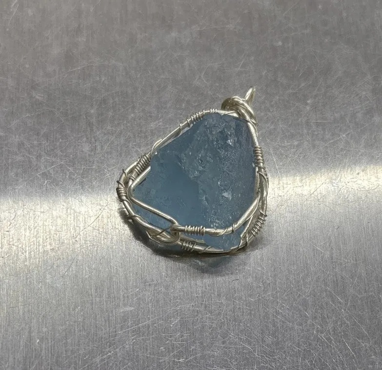 Natural raw aquamarine stone pendant hand-wrapped in gold copper wire with starry sky design