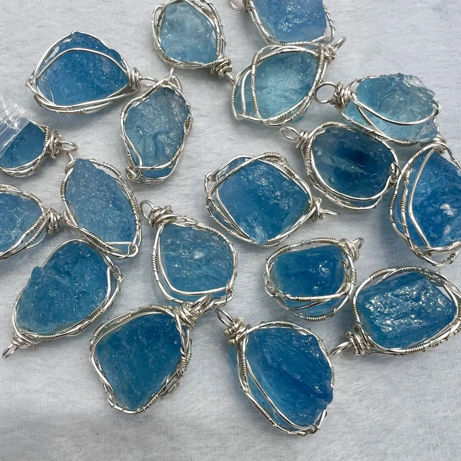 Natural raw aquamarine stone pendant hand-wrapped in gold copper wire with starry sky design