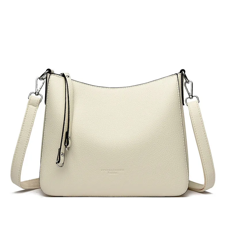 Genuine leather horizontal square shoulder crossbody bag with metal belt detail in beige colour