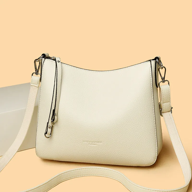 Genuine leather horizontal square shoulder crossbody bag with metal belt detail in beige colour