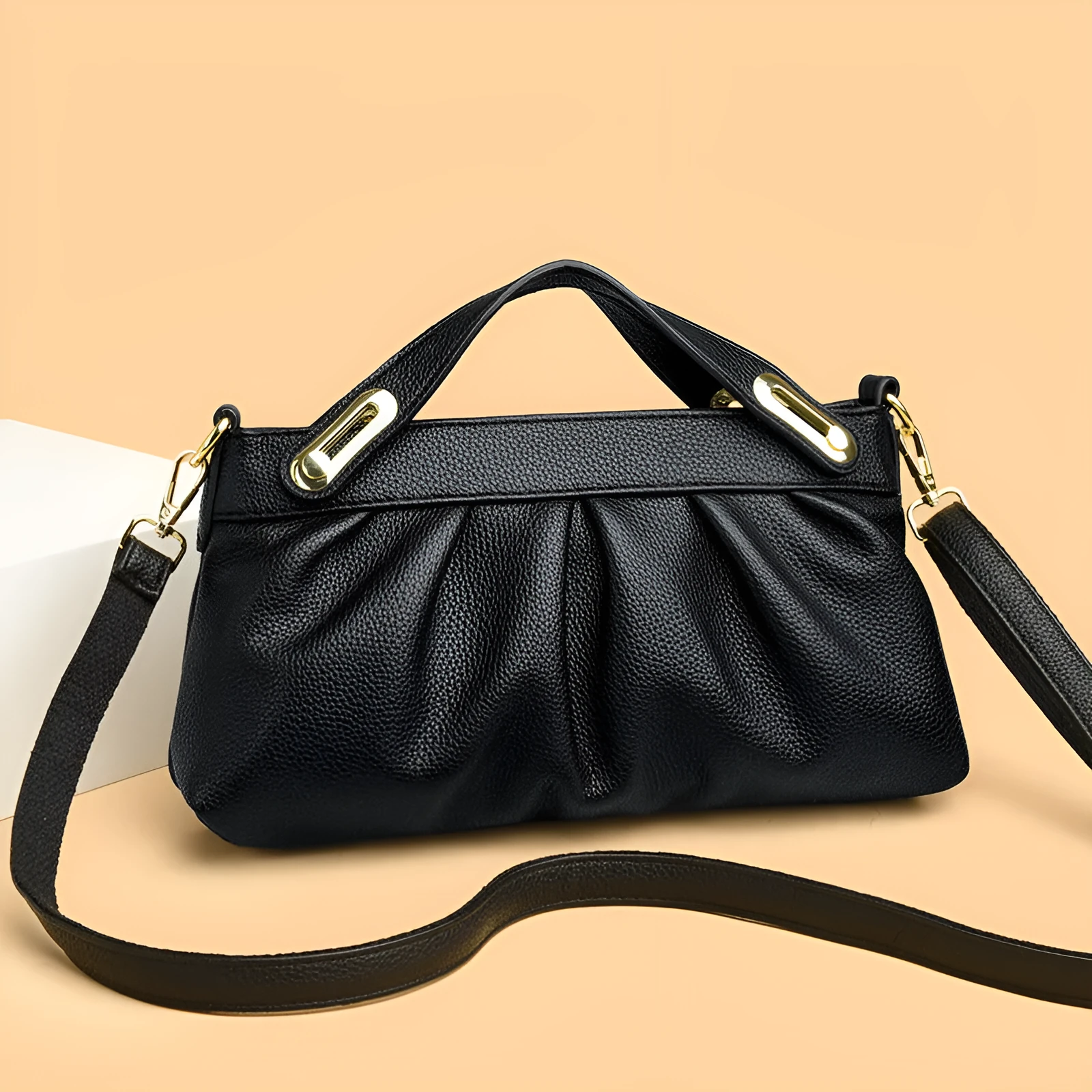 Genuine leather crossbody bag with pleated shoulder strap and wrinkled composite leather finish in horizontal square shape