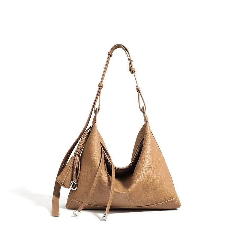 Full-grain leather women's crossbody bag in biscuit with spliced design and zip closure
