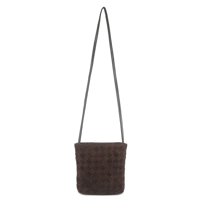 Cowhide leather barrel-shaped zip crossbody bag in black with weaving detail and crossbody strap