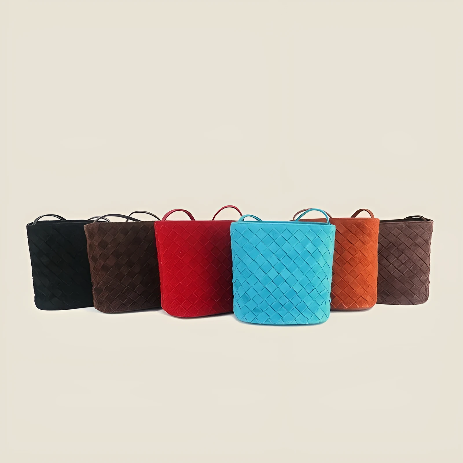 Cowhide leather barrel-shaped zip crossbody bag in black with weaving detail and crossbody strap