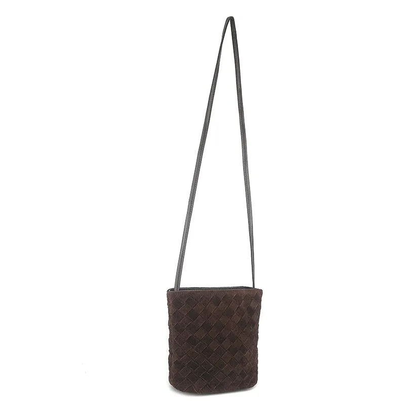 Cowhide leather barrel-shaped zip crossbody bag in black with weaving detail and crossbody strap