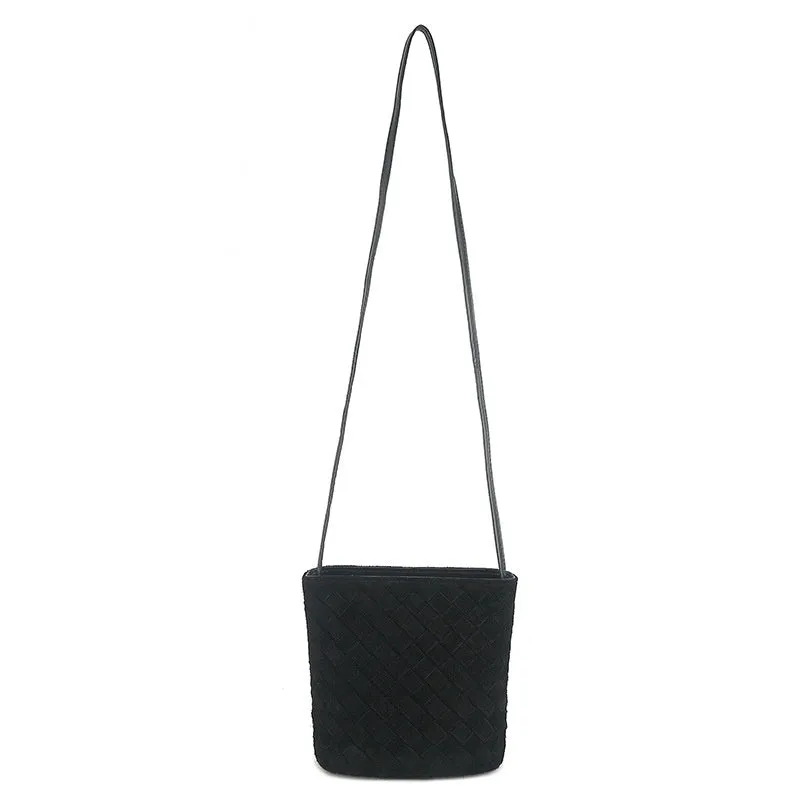 Cowhide leather barrel-shaped zip crossbody bag in black with weaving detail and crossbody strap