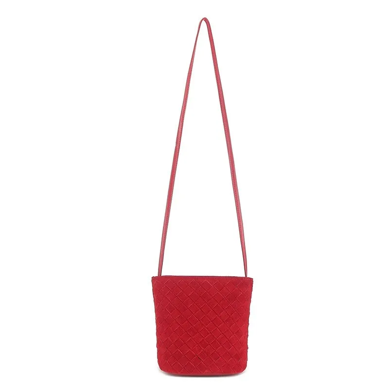 Cowhide leather barrel-shaped zip crossbody bag in black with weaving detail and crossbody strap