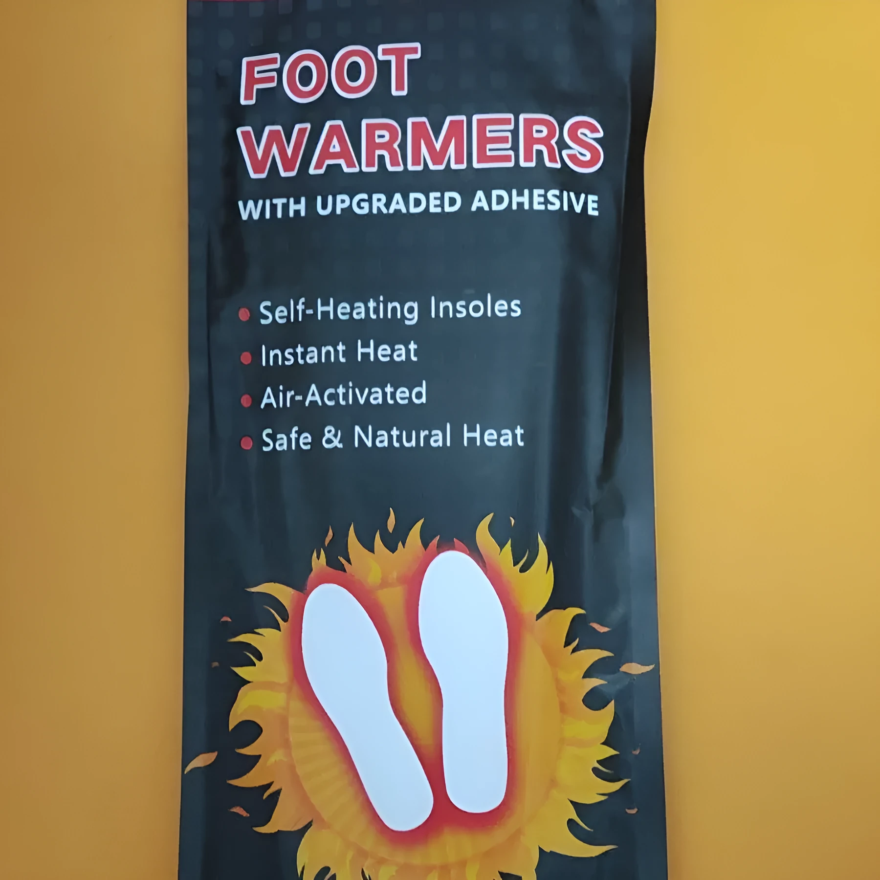 Self-heating foot warmer insoles in two sizes, walkable and battery-free, placed inside a pair of boots
