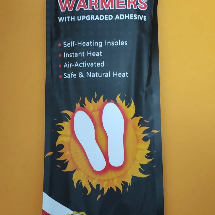 Self-heating foot warmer insoles in two sizes, walkable and battery-free, placed inside a pair of boots