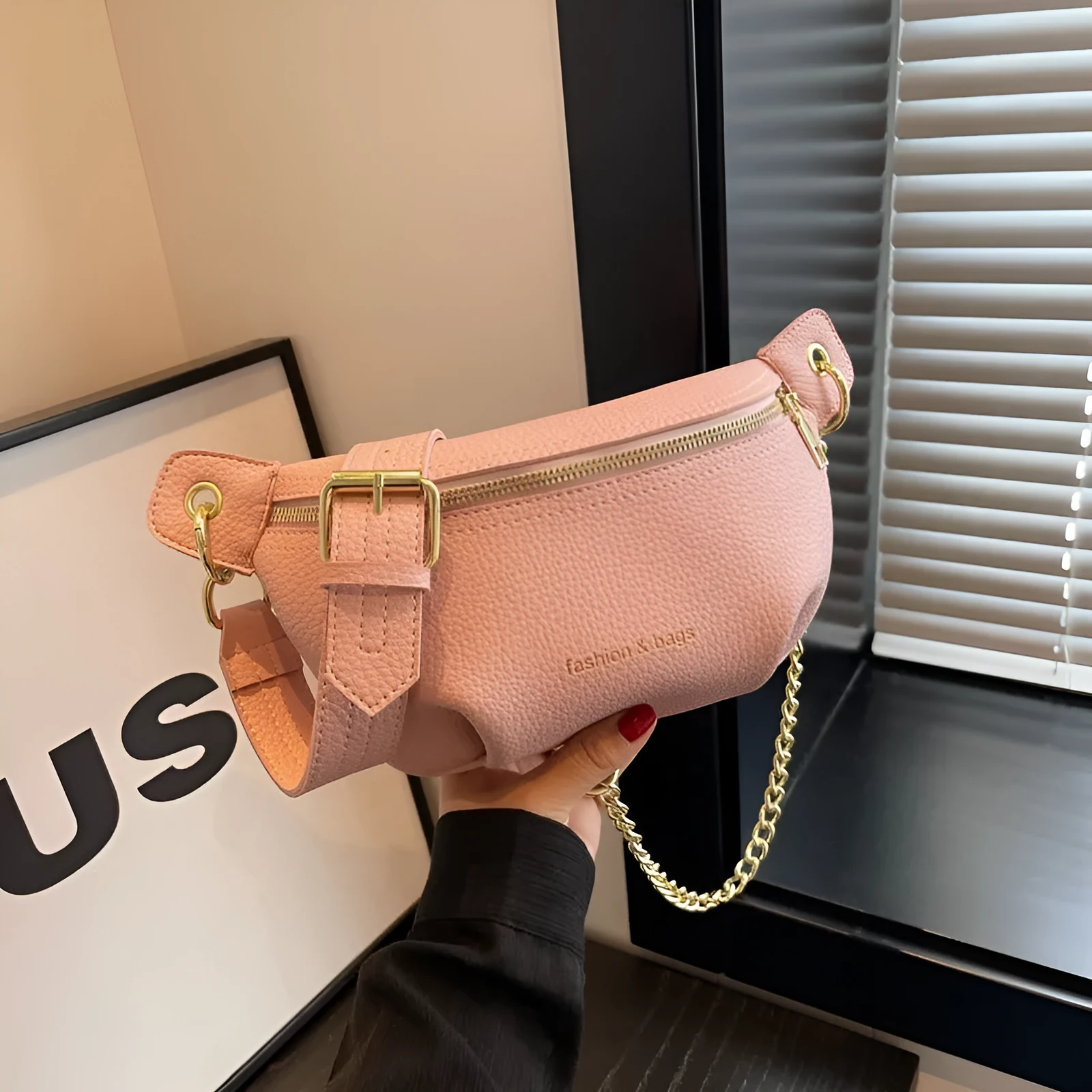 PU waist bag with spliced design in black showing single-shoulder style and zippered compartment