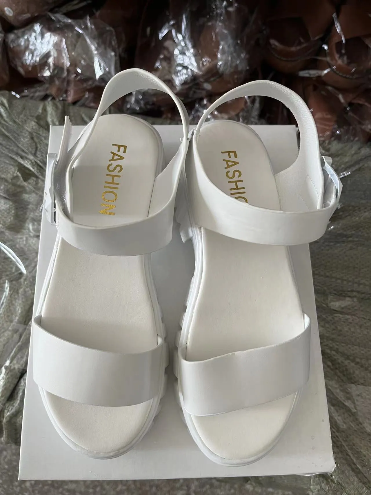 Women's beige peep toe platform sandals with an ankle-strap buckle on a white background