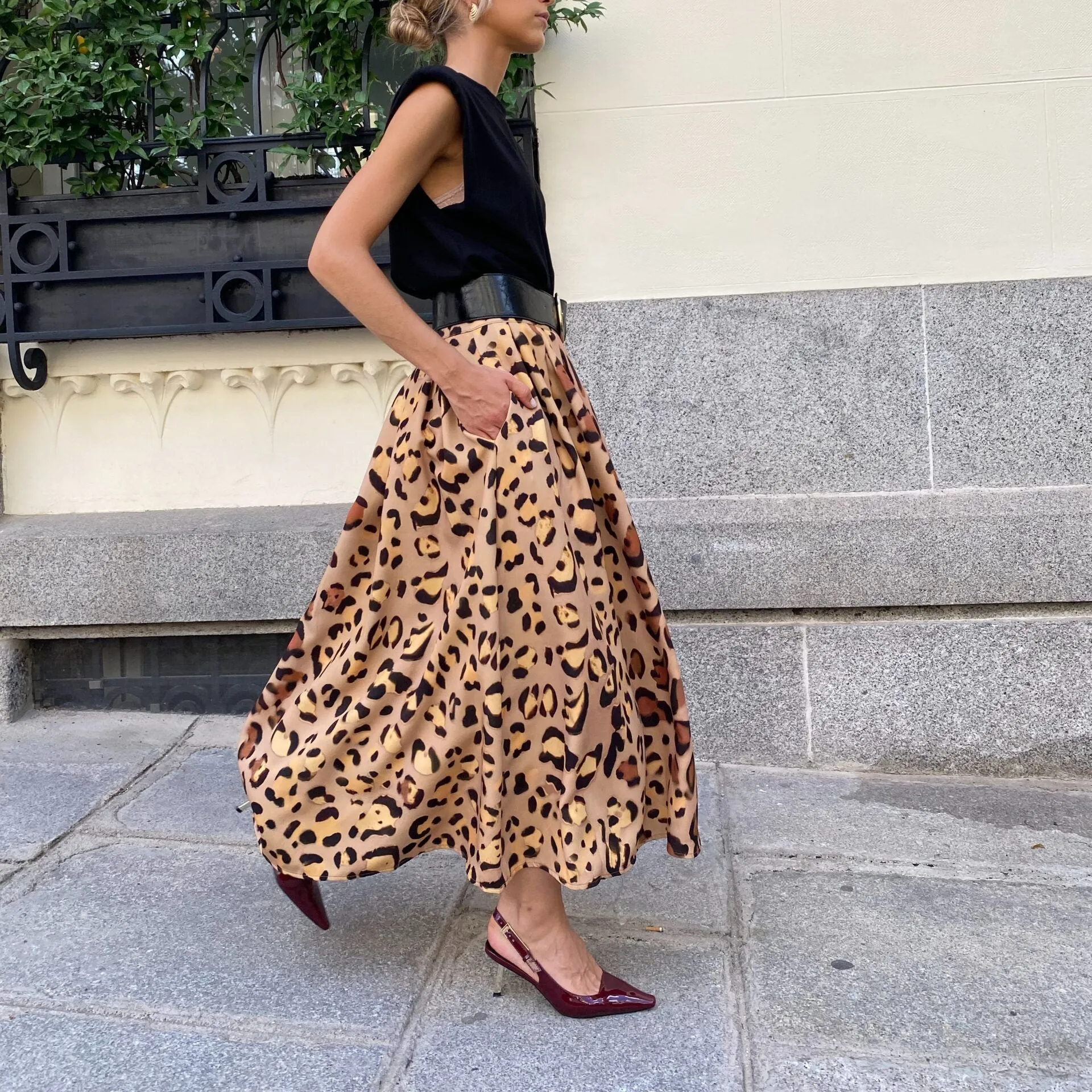 Brown leopard print women's A-line long skirt on a hanger.