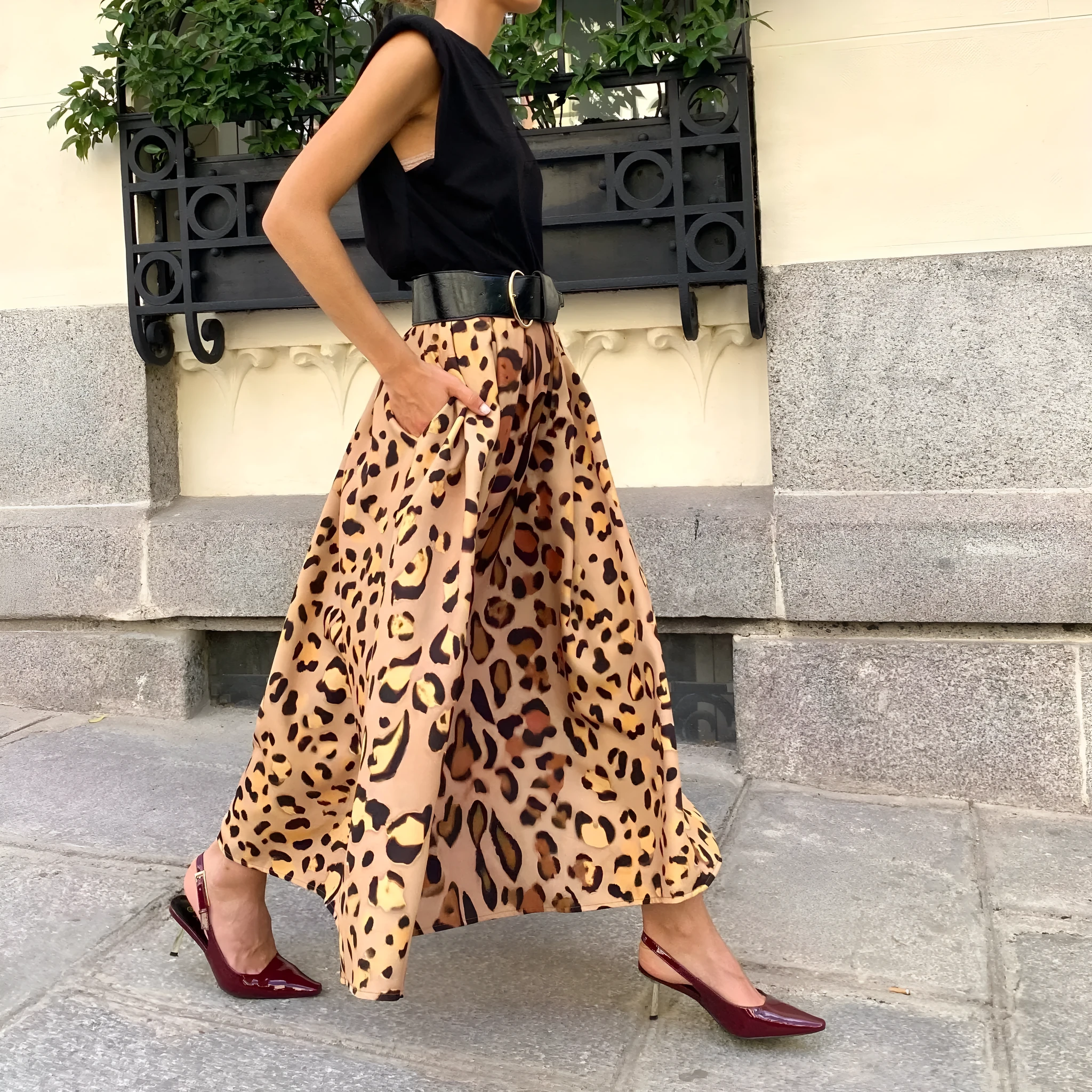Brown leopard print women's A-line long skirt on a hanger.