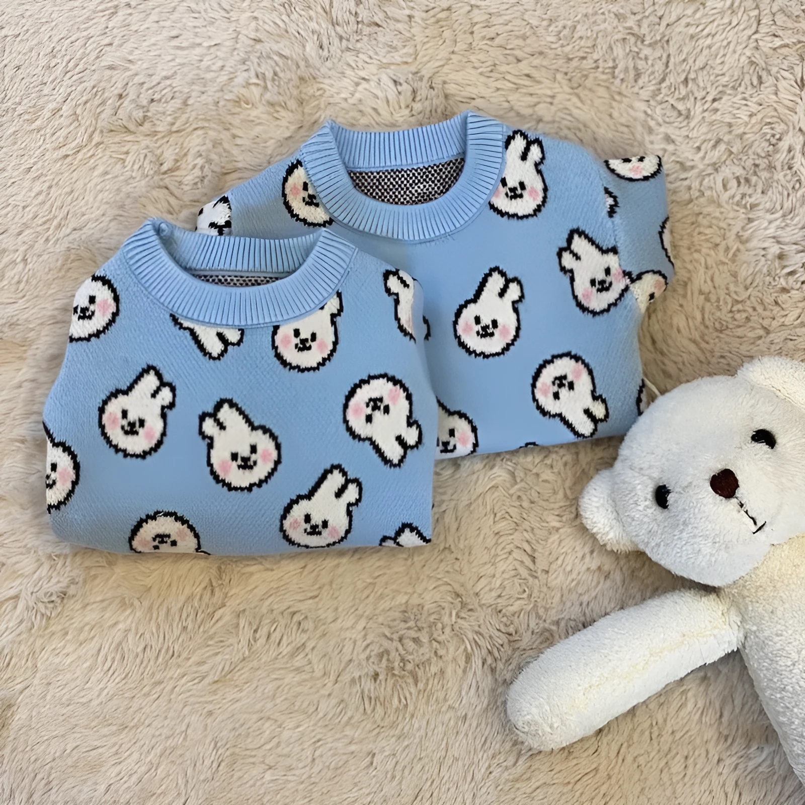Small dog wearing a blue winter knitted sweater with charming patterns, soft polyacrylic material, side view