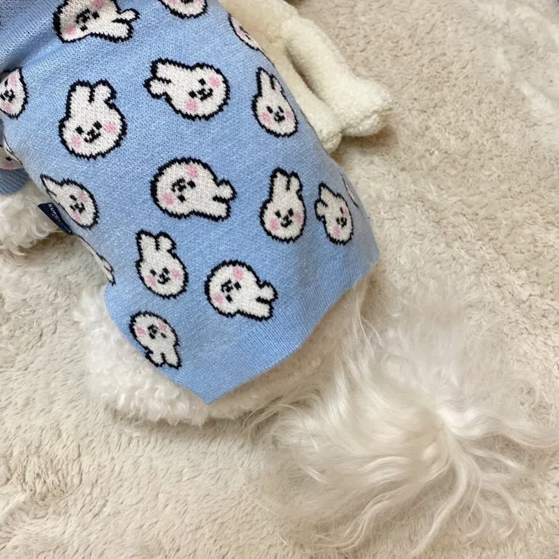 Small dog wearing a blue winter knitted sweater with charming patterns, soft polyacrylic material, side view