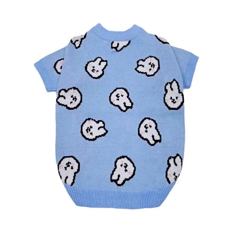 Small dog wearing a blue winter knitted sweater with charming patterns, soft polyacrylic material, side view
