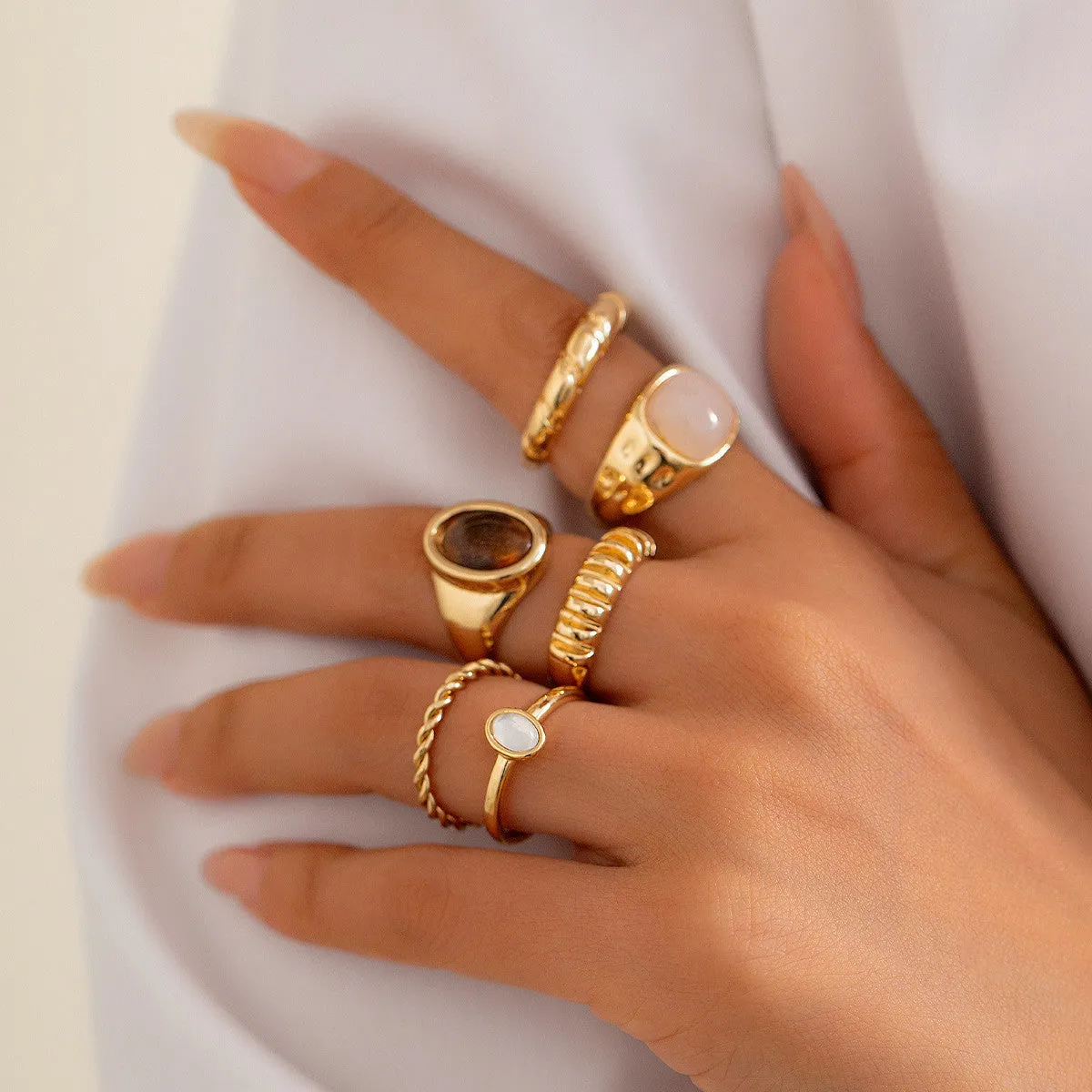 Set of six light gold geometric and round alloy rings with electroplated finish