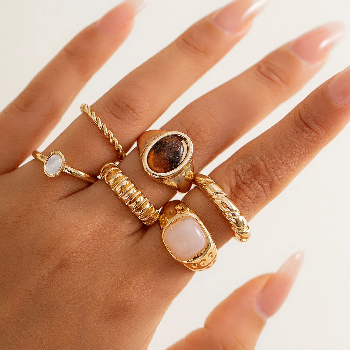 Set of six light gold geometric and round alloy rings with electroplated finish