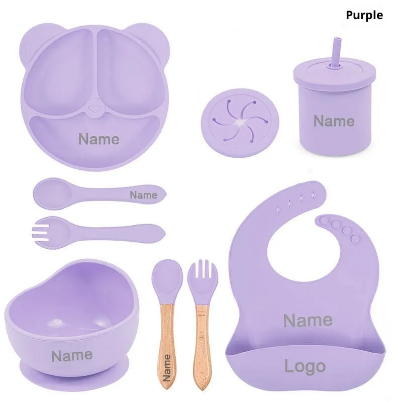 Children's silicone tableware set with cat ear cup in beige, blue and other colours on a table