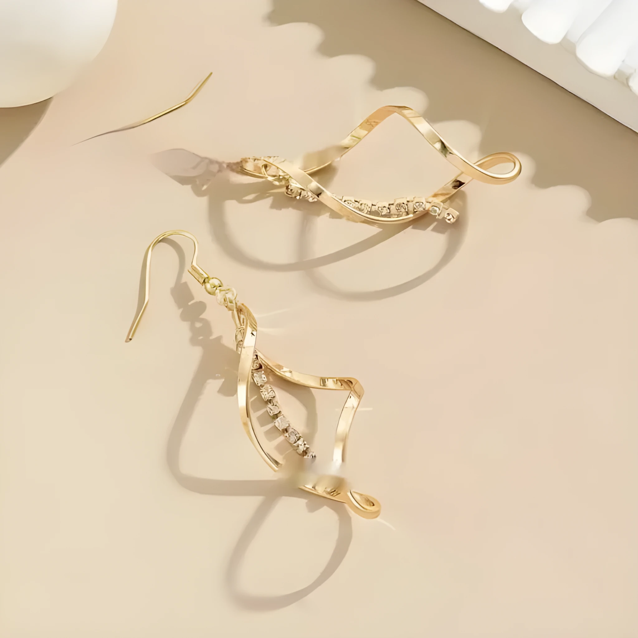Gold geometric spiral earrings with ellipse elements and electroplated finish