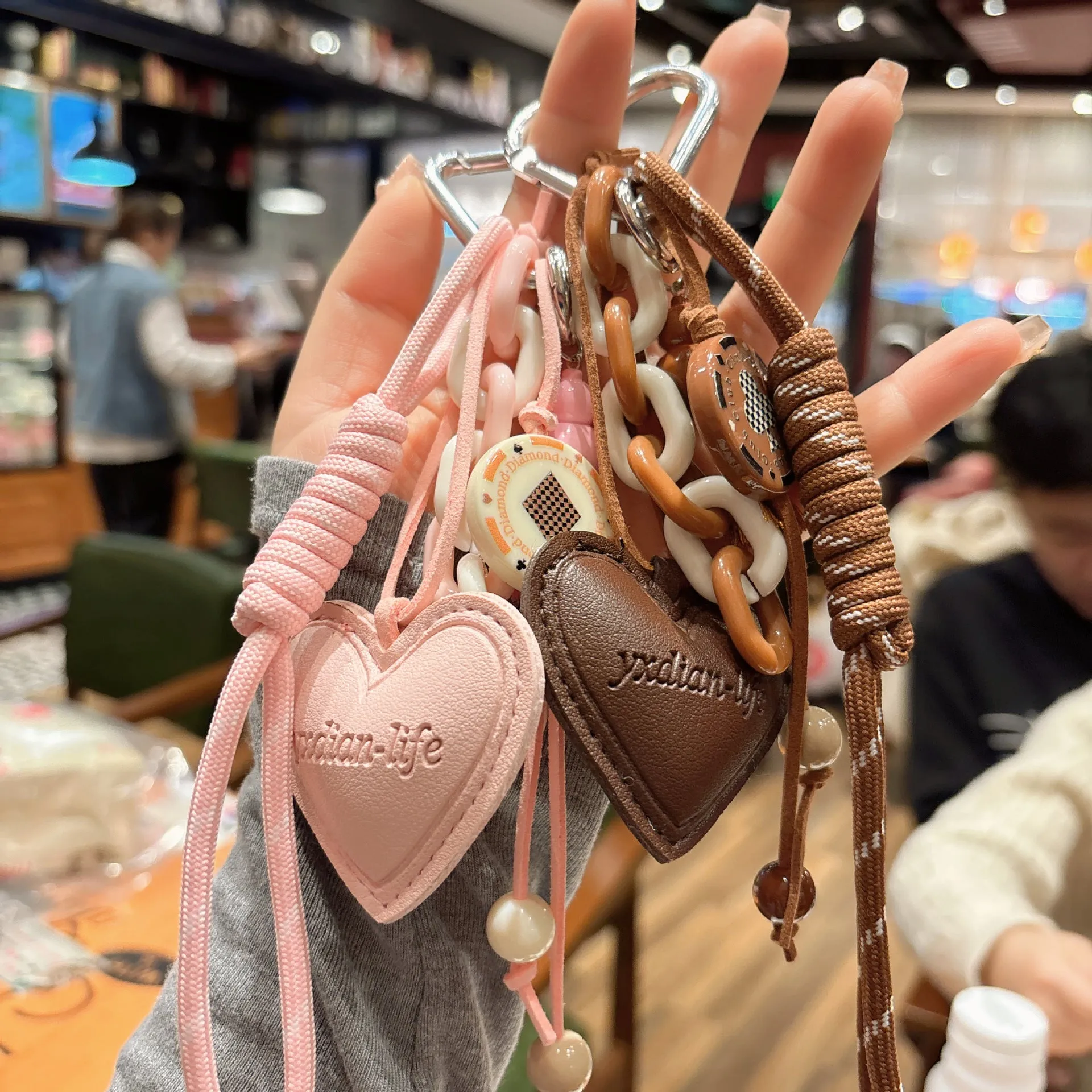 Leather keychain with heart-shaped small gourd pendant in brown, woven rope strap