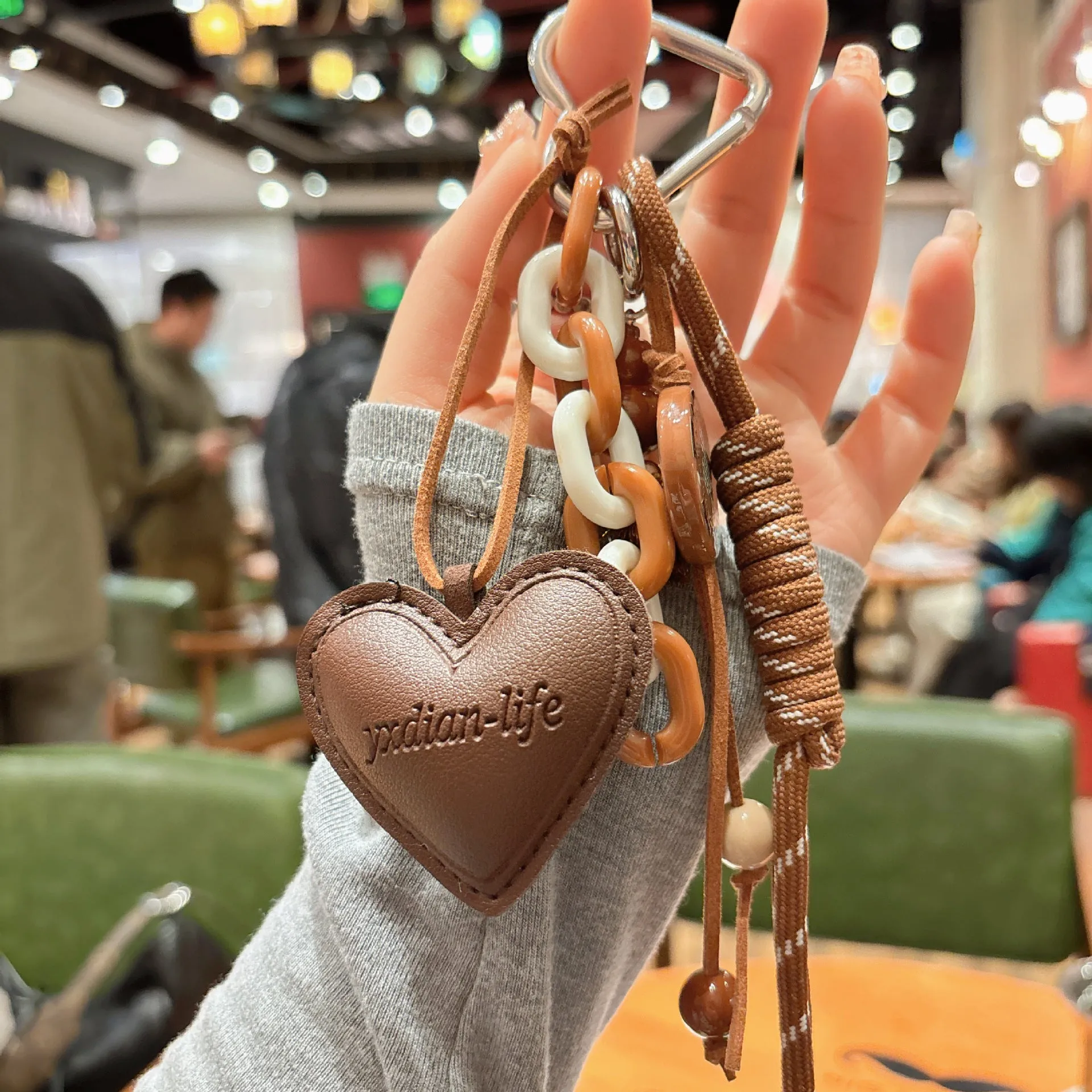 Leather keychain with heart-shaped small gourd pendant in brown, woven rope strap