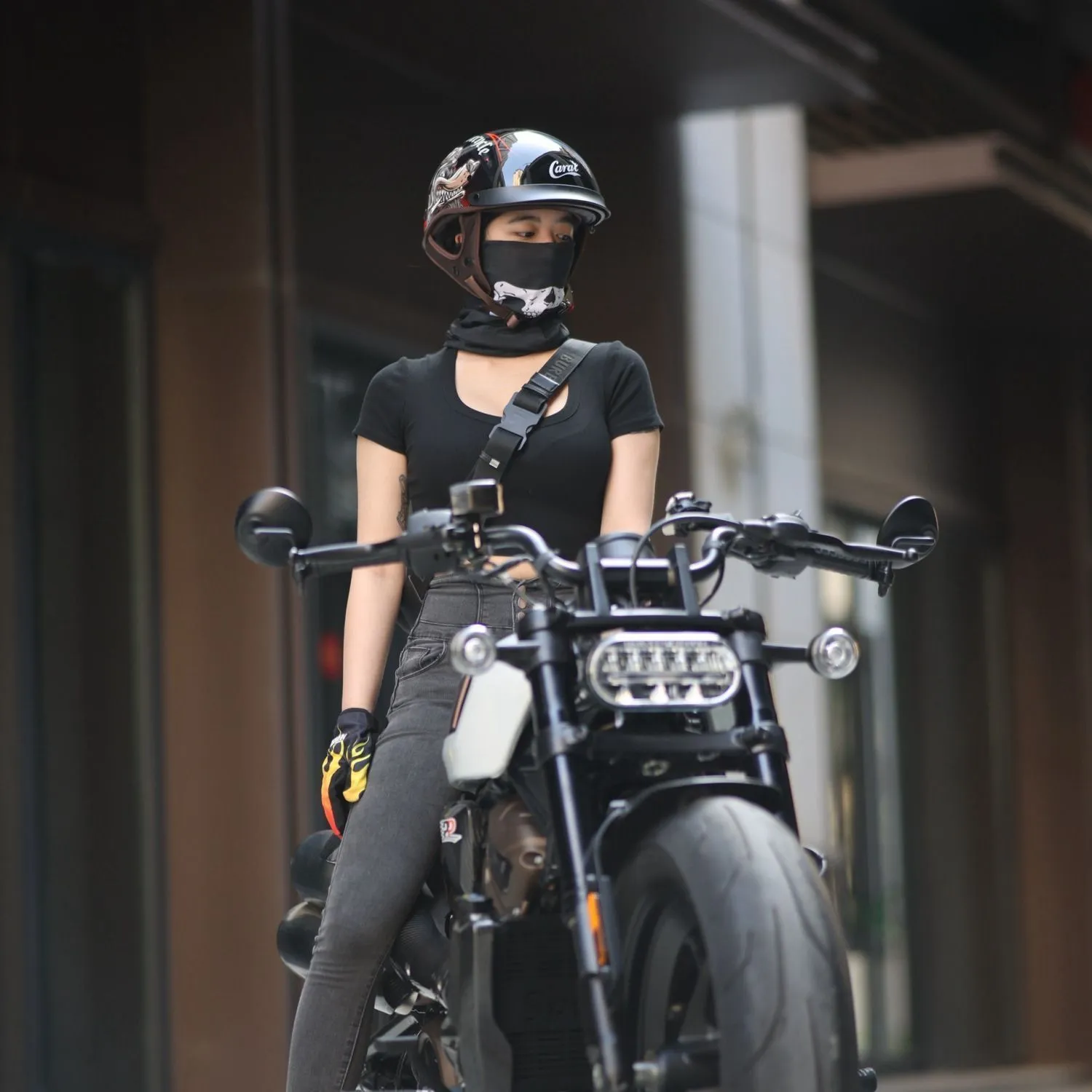 Retro electric motorcycle helmet in matte black with Whirlwind Dog graphic, shown on a rider.