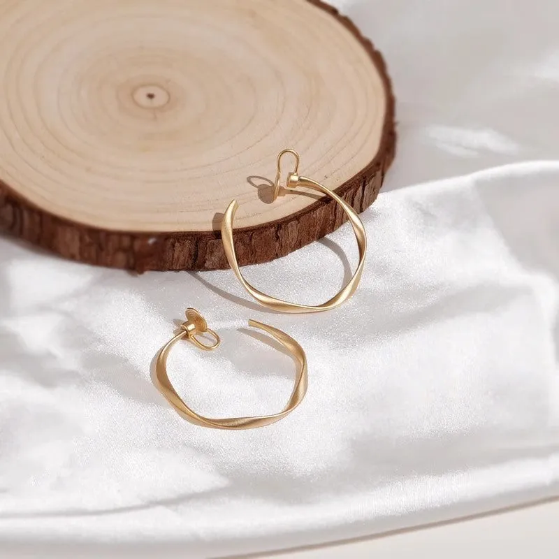 Rotatable circle mosquito coil ear clip in matte gold with rubber pads for women