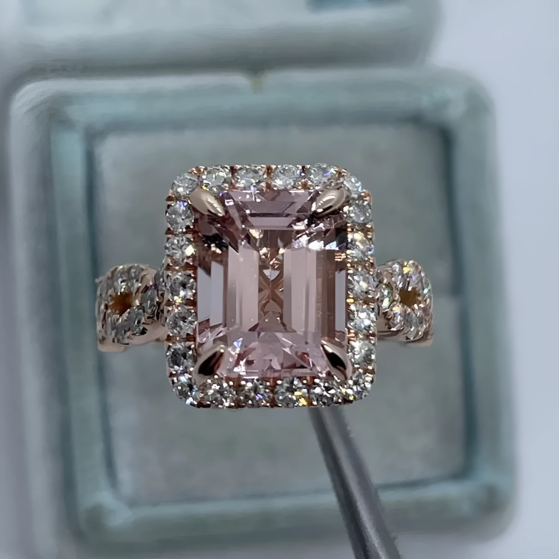 Rose gold geometric alloy ring on a plain background, showing its shape and electroplated finish.