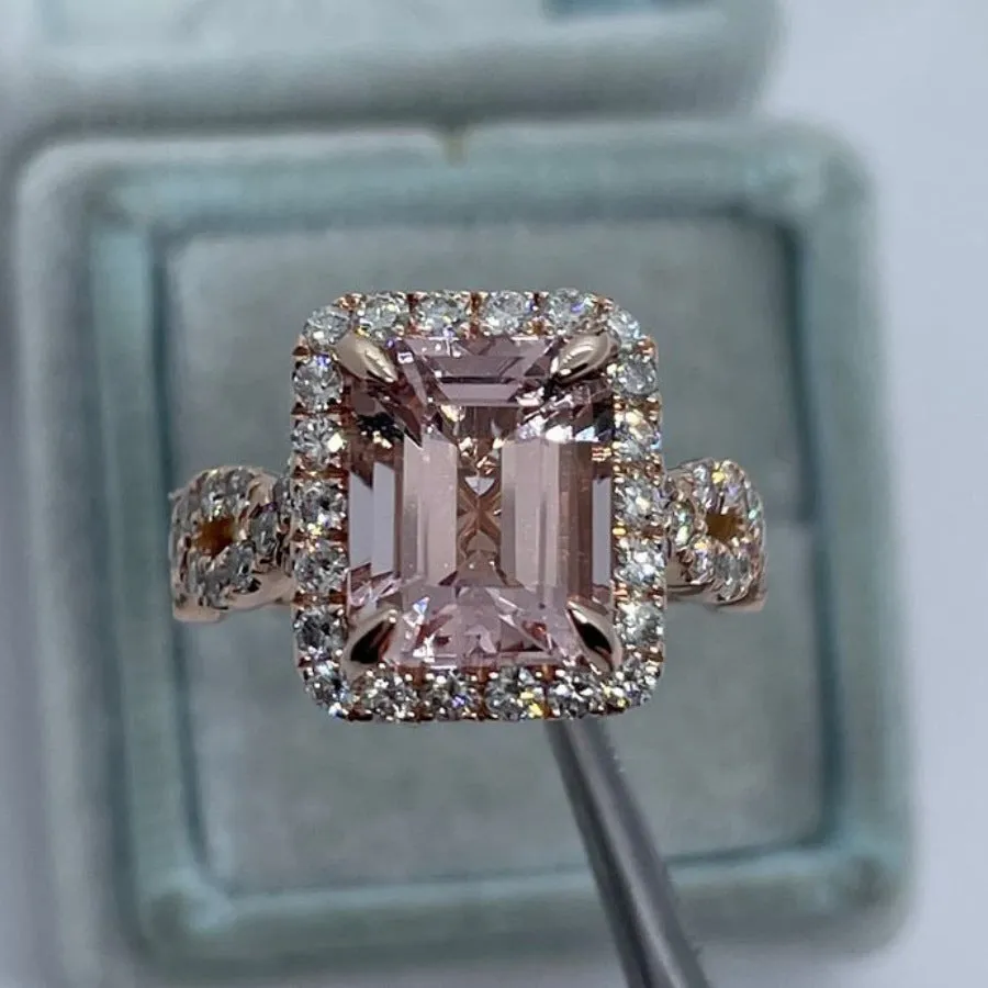 Rose gold geometric alloy ring on a plain background, showing its shape and electroplated finish.