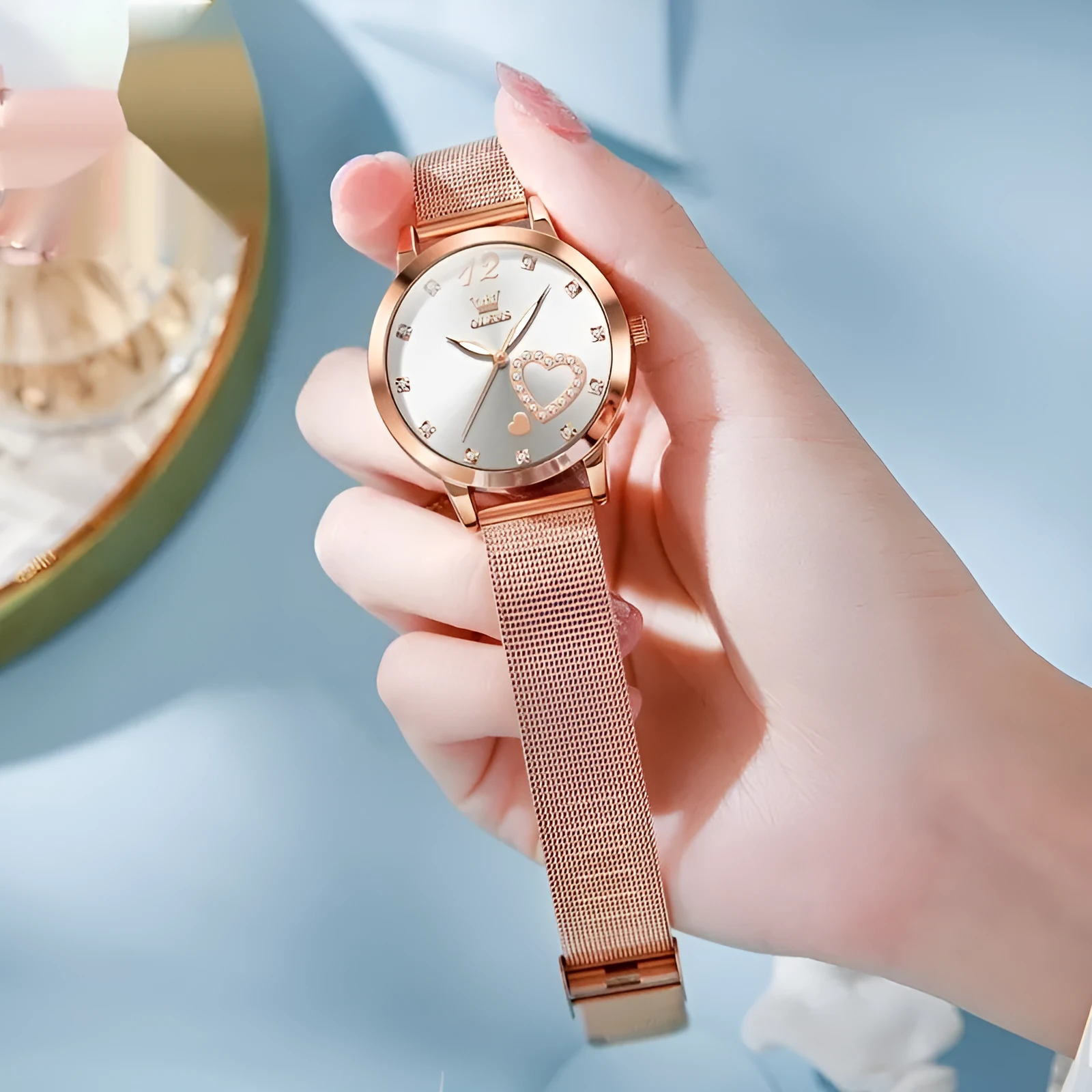 Women's fashion watch with rose alloy case, coloured dial, and stainless steel mesh strap.
