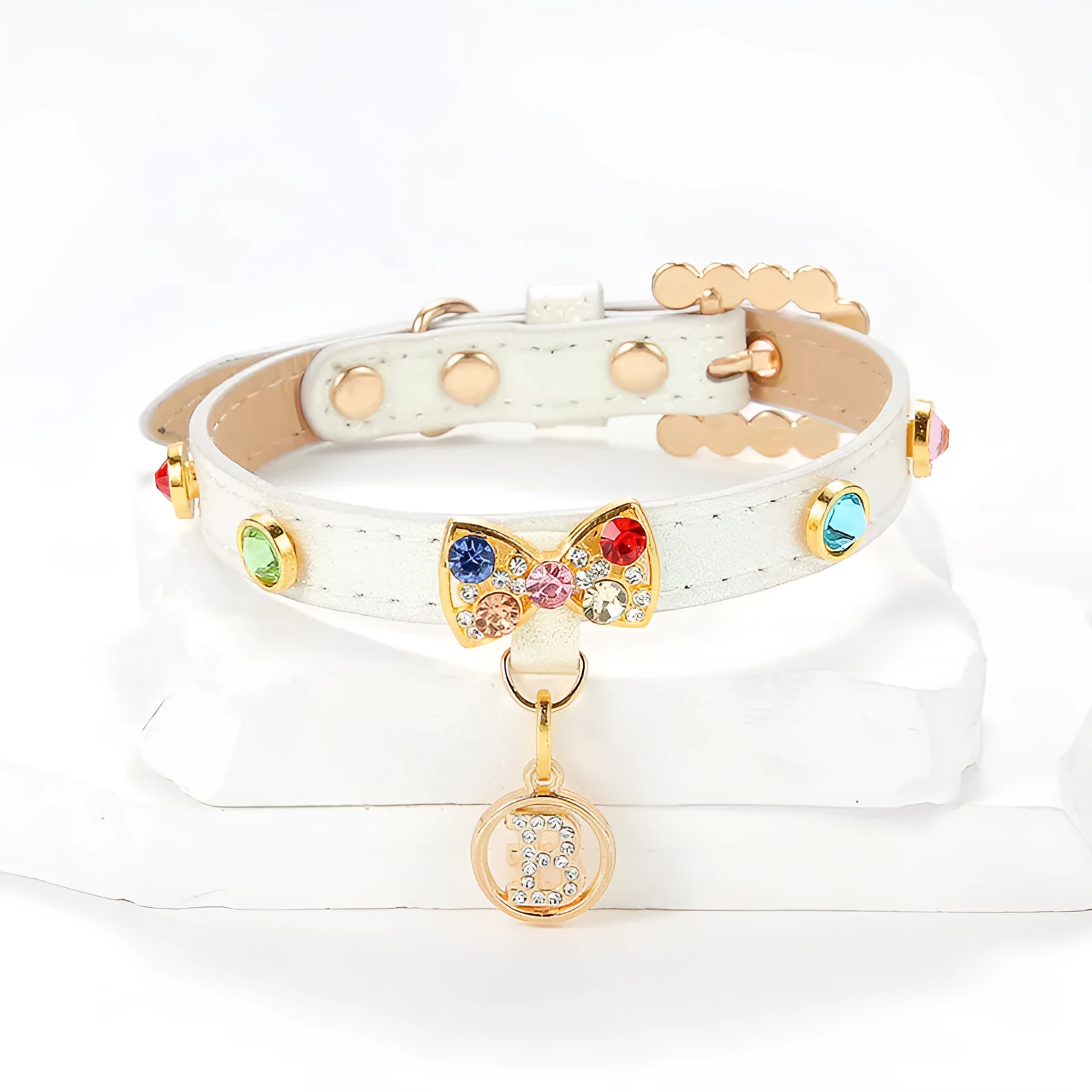 White PU cat collar with diamond alloy bow on a flat surface showing buckle and bow detail