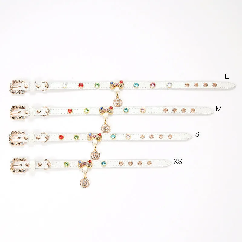 White PU cat collar with diamond alloy bow on a flat surface showing buckle and bow detail