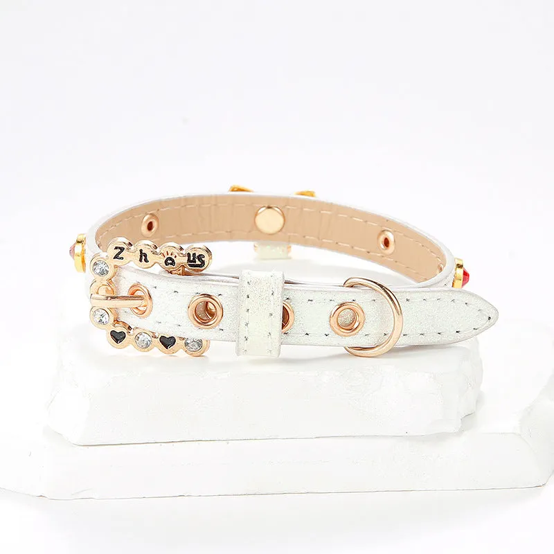 White PU cat collar with diamond alloy bow on a flat surface showing buckle and bow detail