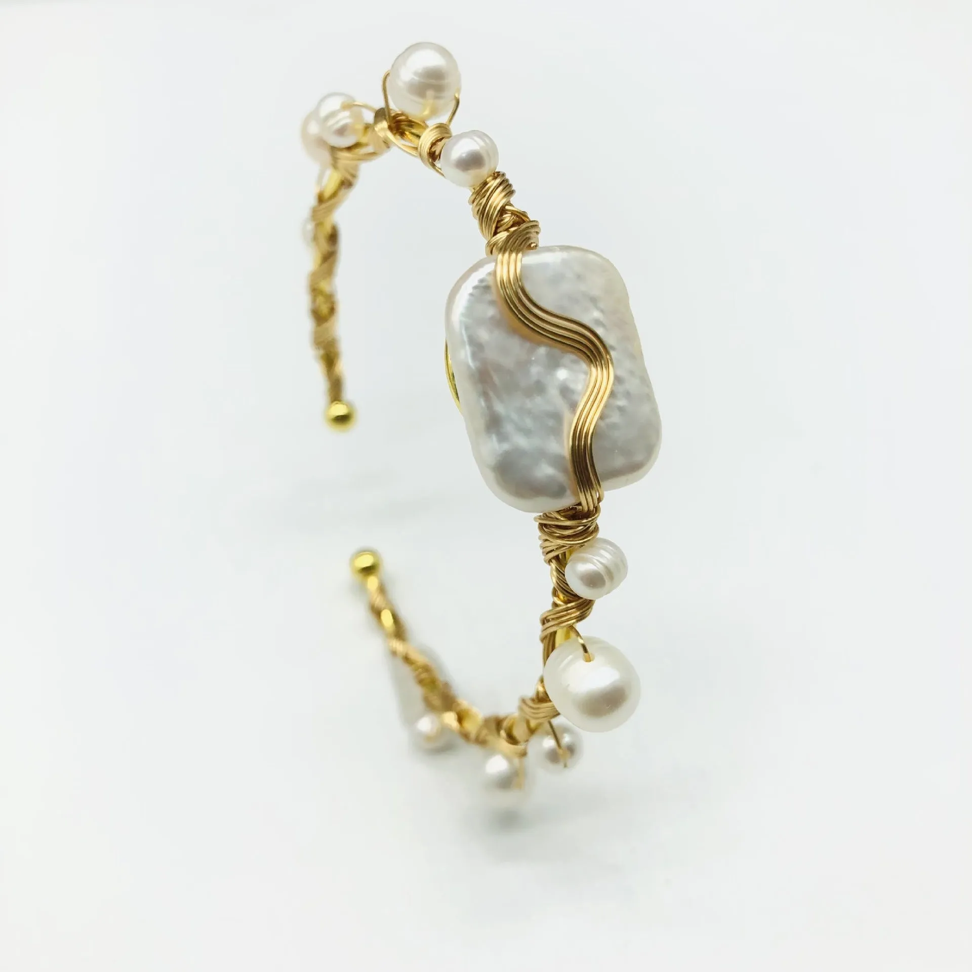 Natural freshwater pearl handmade wire-wrapped bracelet in gold titanium steel on wrist