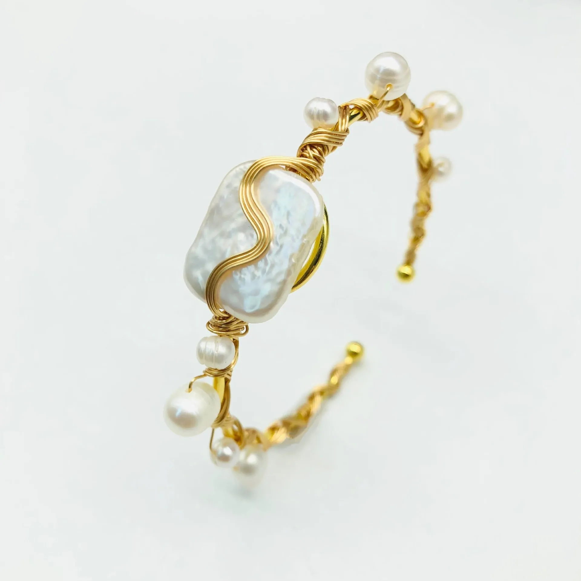 Natural freshwater pearl handmade wire-wrapped bracelet in gold titanium steel on wrist