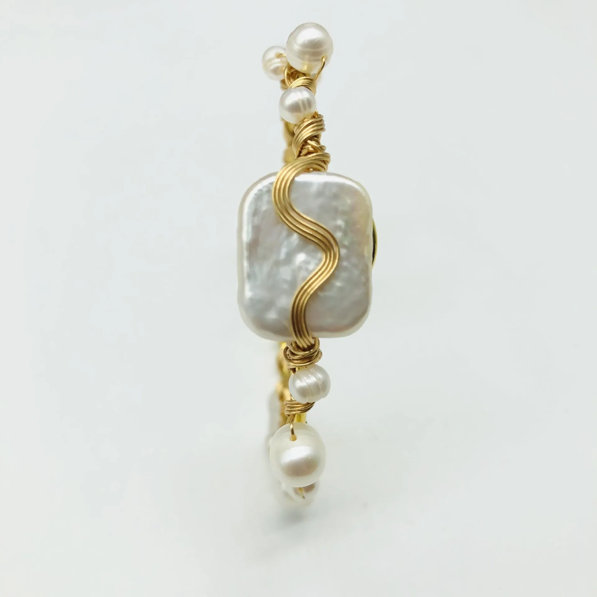 Natural freshwater pearl handmade wire-wrapped bracelet in gold titanium steel on wrist