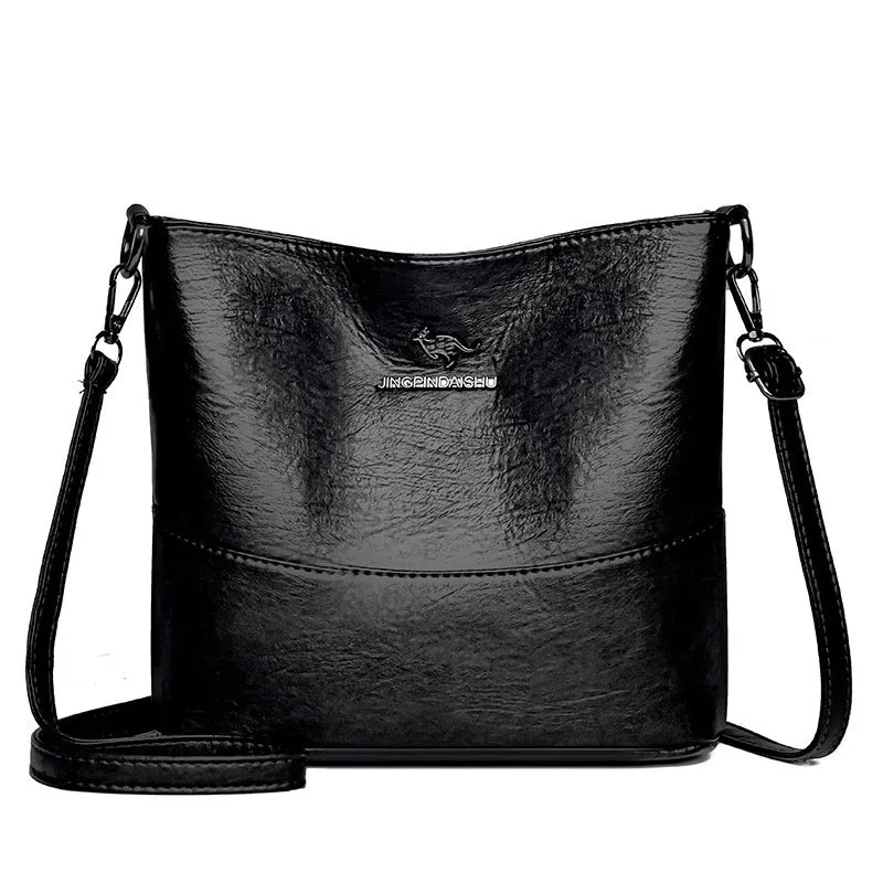 Women's soft leather bucket shoulder bag in black with sewing line detailing and mobile phone pocket