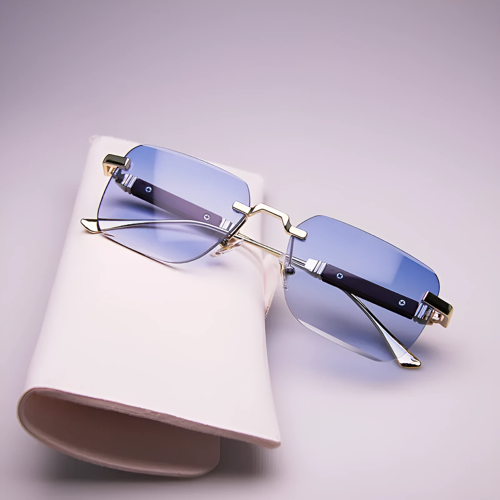 Frameless edge-cut sunglasses with gold frame, wood grain legs, and gradient grey lenses on a neutral background